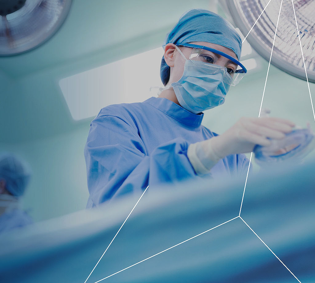 Guidehouse Nurse in scrubs and mask in surgery