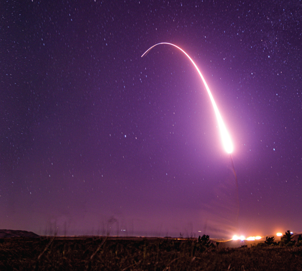 Intercontinental ballistic missile flying throughout purple sky