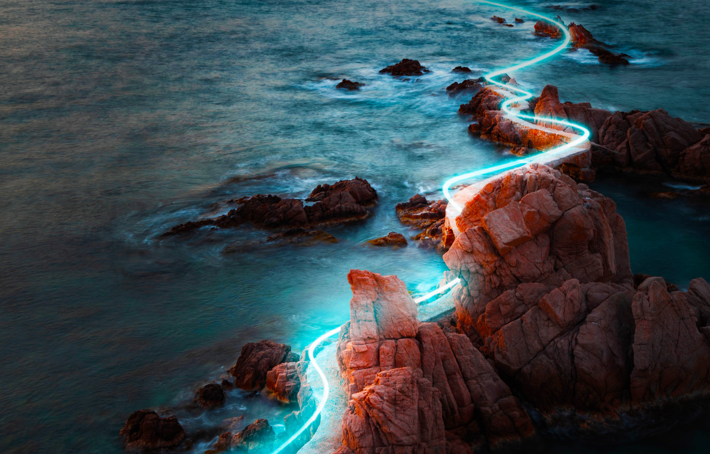 glowing path of light through rocky coastline