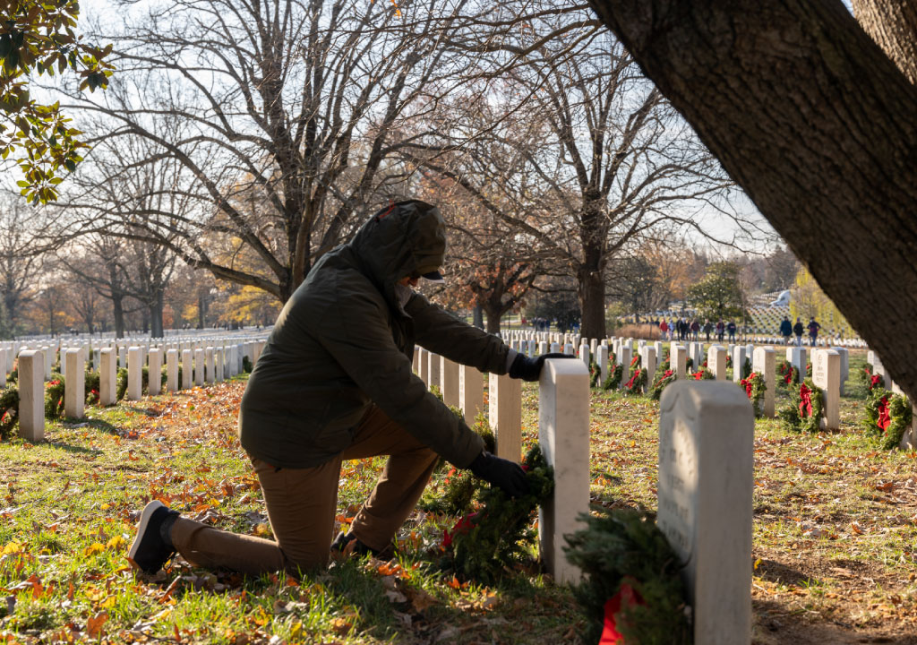 Man Kneeling in front of Tomb at Arlington Cemetary