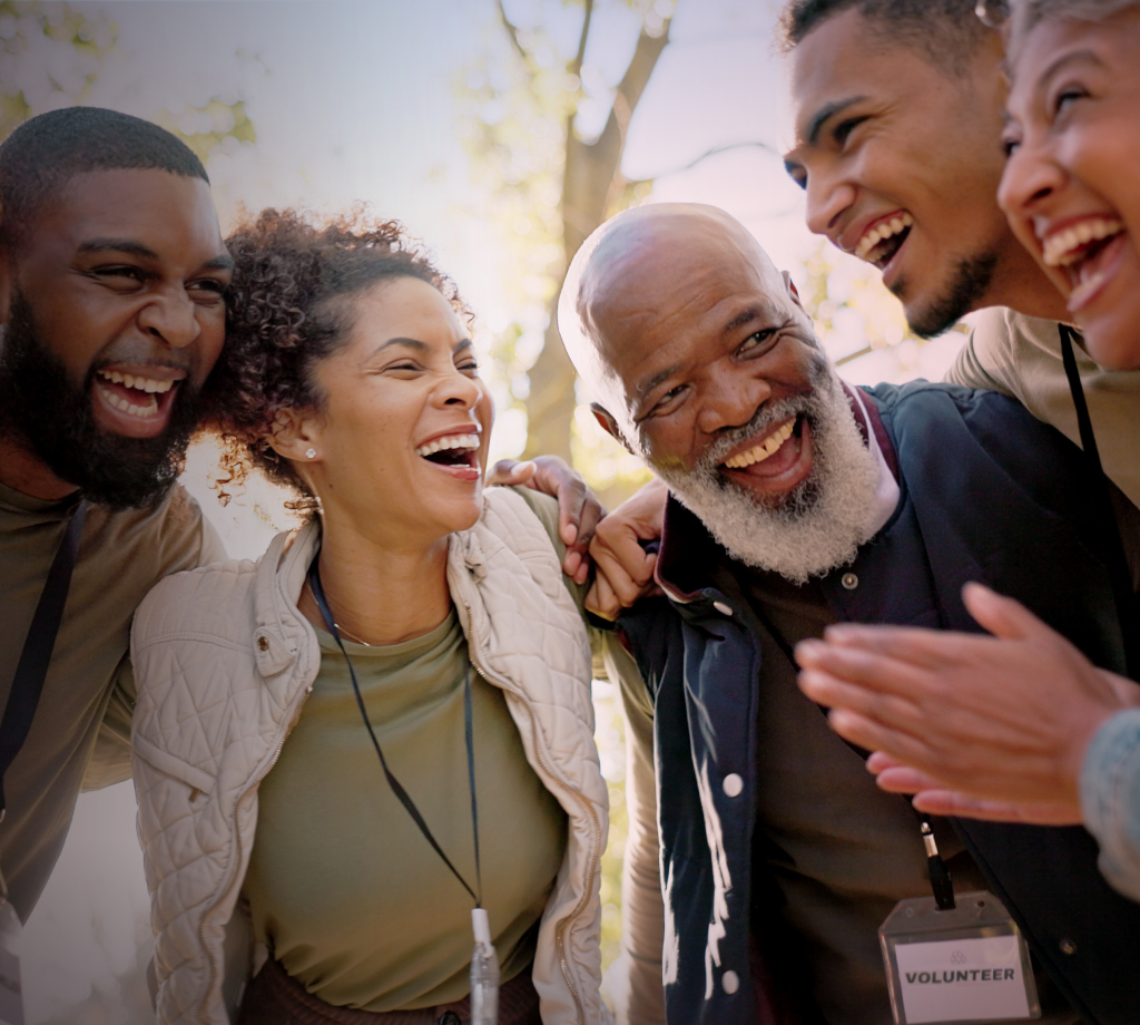 Group of people huddling and smiling 