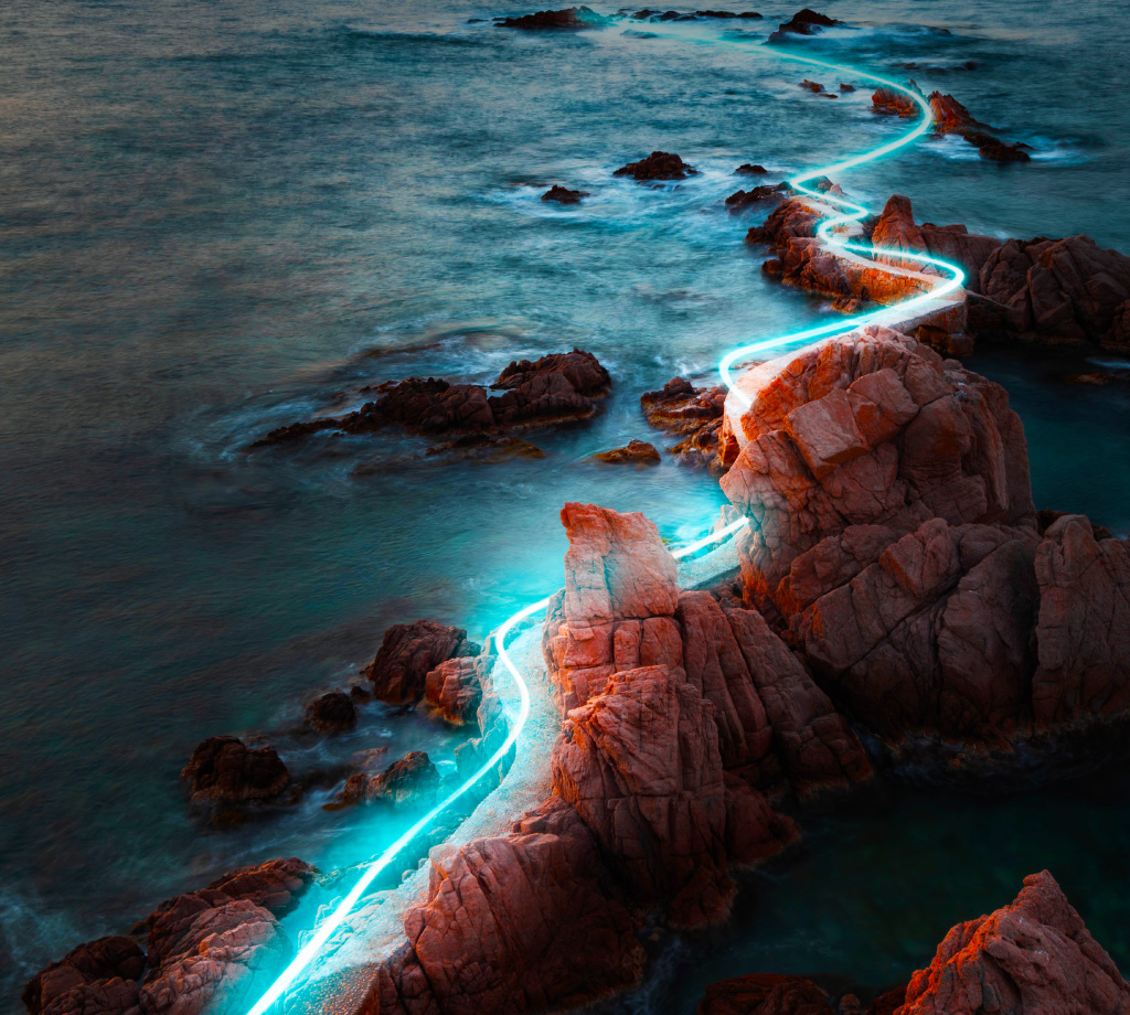 glowing path of light through rocky coastline
