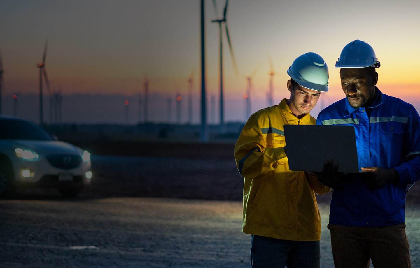 Two Electric engineers working at a wind turbine farm