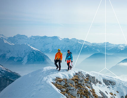 Two hikers on top of snow mountain top