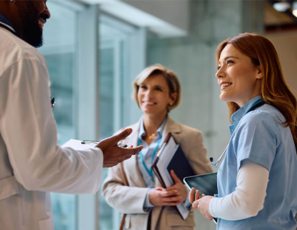 Nurse and health professional discussing with doctor