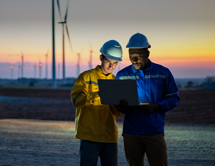 Two Electric engineers working at a wind turbine farm