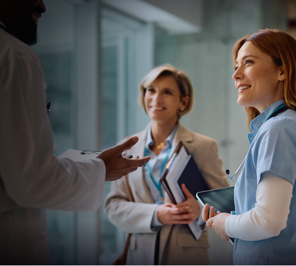 Nurse and health professional discussing with doctor
