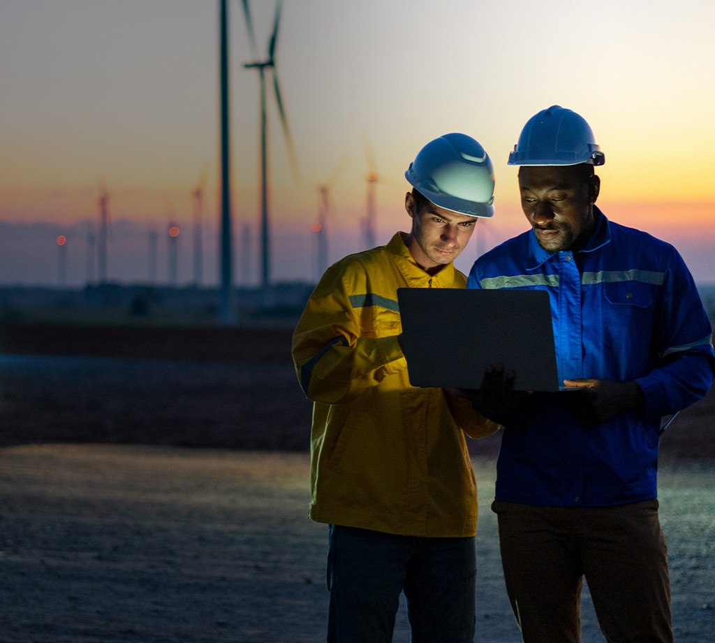 Two Electric engineers working at a wind turbine farm