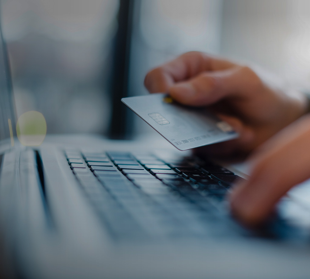 person entering credit card information on laptop