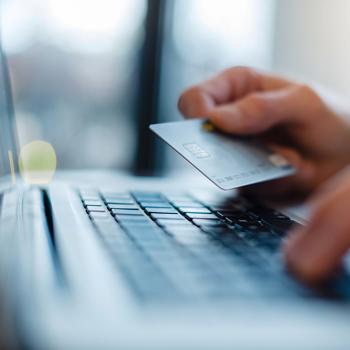person entering credit card information on laptop
