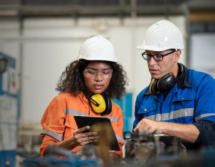 Two construction workers looking at ipad