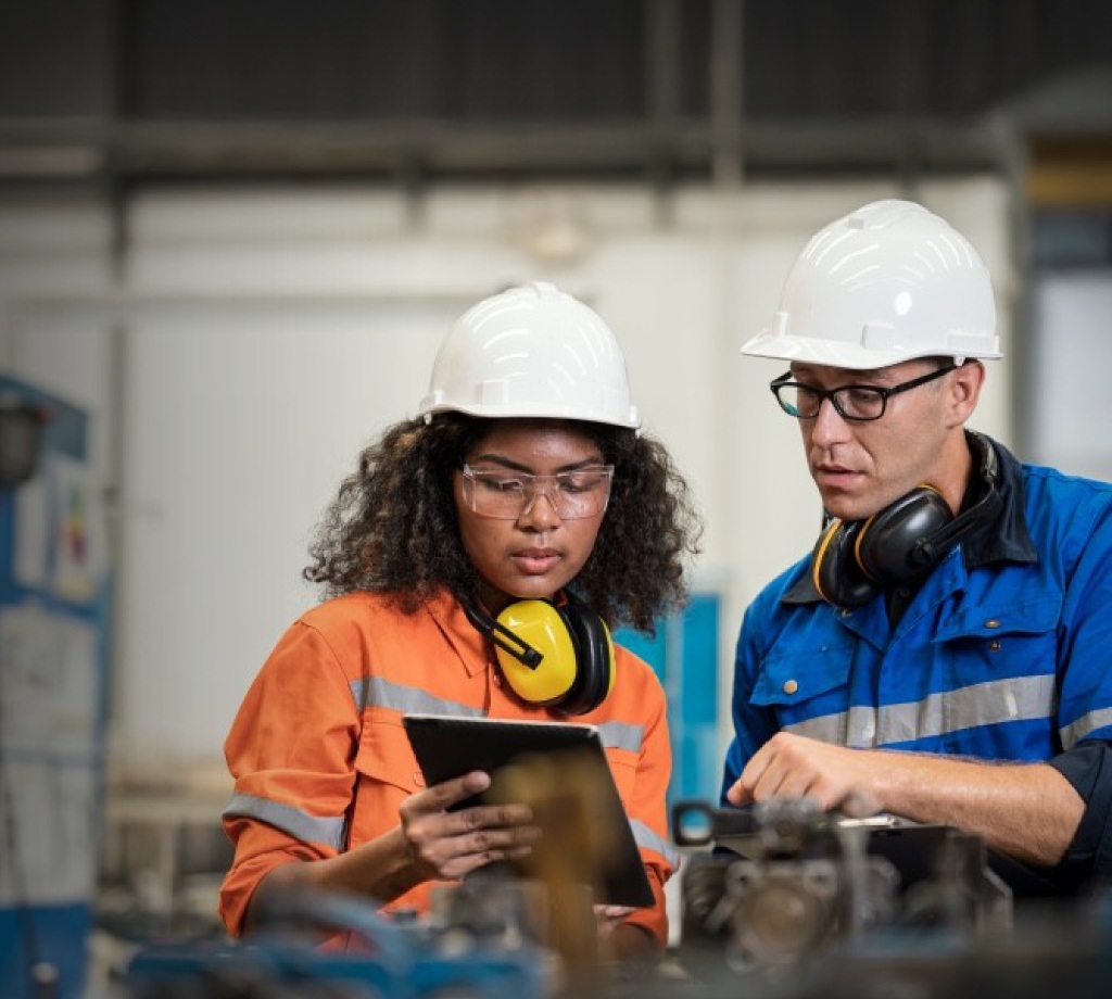 Two construction workers looking at ipad