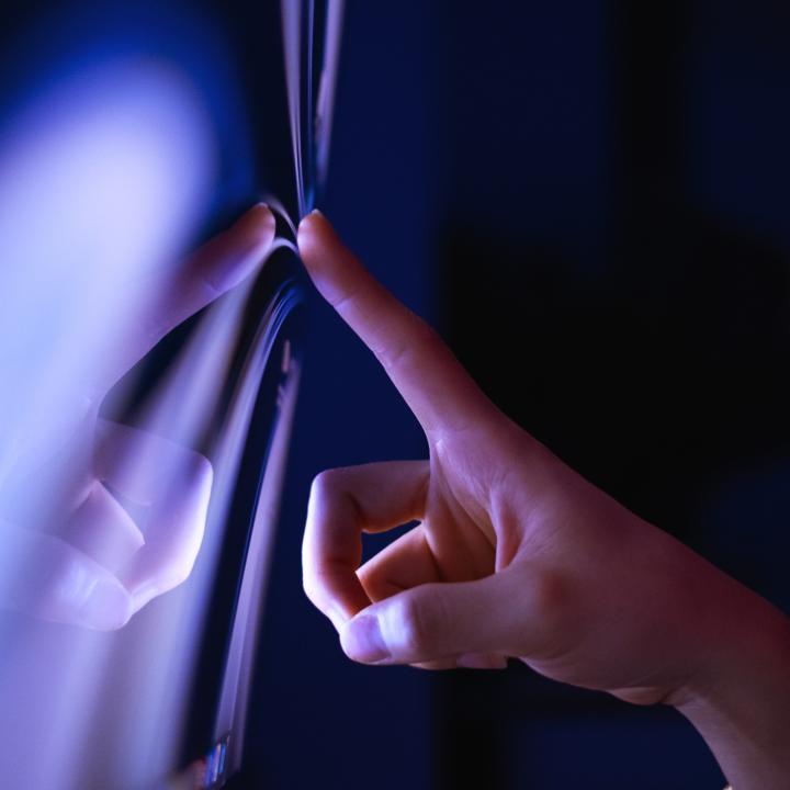 Close-up of clicking on touch screen with purple luminating lights