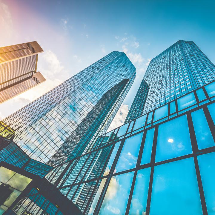Bottom view of modern skyscrapers in business district in beautiful evening light at sunset 