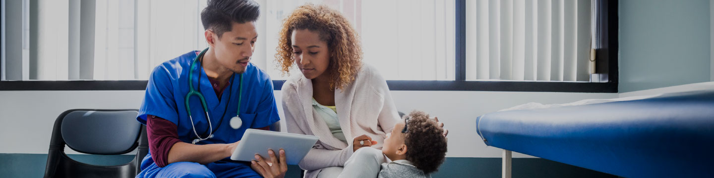 Doctor, patient and young boy in doctor office