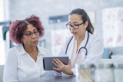 Two doctors looking at ipad