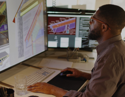 Man looking at architecture on computer
